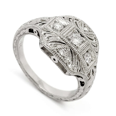 Art Deco style 19kt white gold engagement ring with bead-set round diamonds and millgrain detail