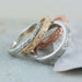 Assorted engraved wedding rings in white, yellow, and rose gold with millgrain detail