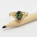 Oval Australian sapphire and diamond 14kt yellow gold ring shown beside pencil for scale