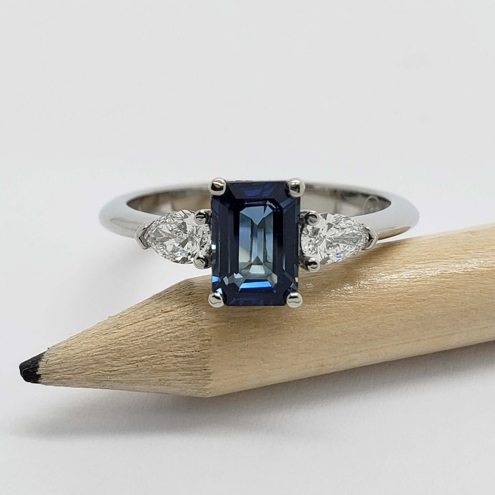 Australian sapphire and diamond 3-stone ring in white gold, shown on a pencil for scale