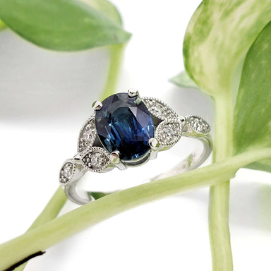 Australian sapphire and diamond engagement ring in white gold, styled with greenery