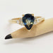 Australian sapphire and diamond engagement ring in yellow gold, displayed on a pencil