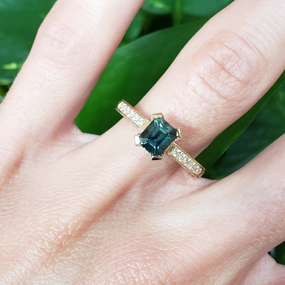 14kt yellow gold Australian sapphire and diamond engagement ring on hand, showcasing engraved band