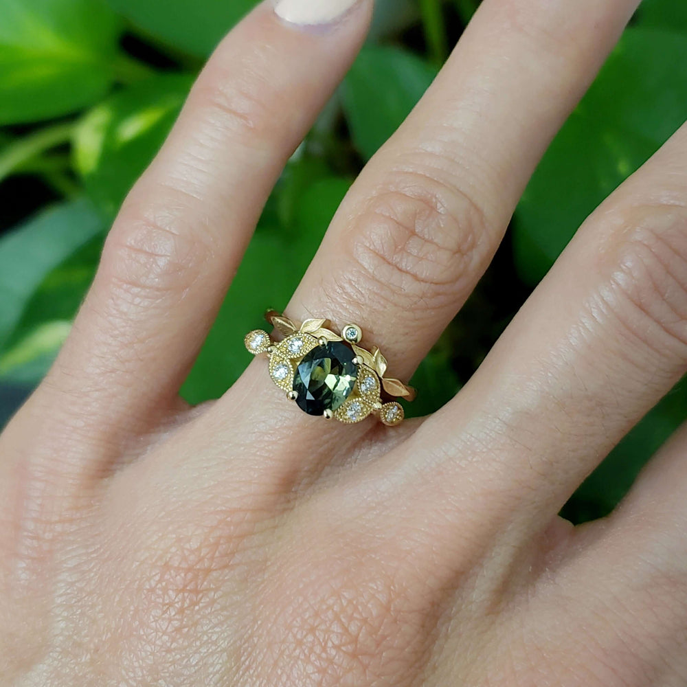 Australian sapphire and diamond engagement ring stacked with leaf-inspired yellow gold band