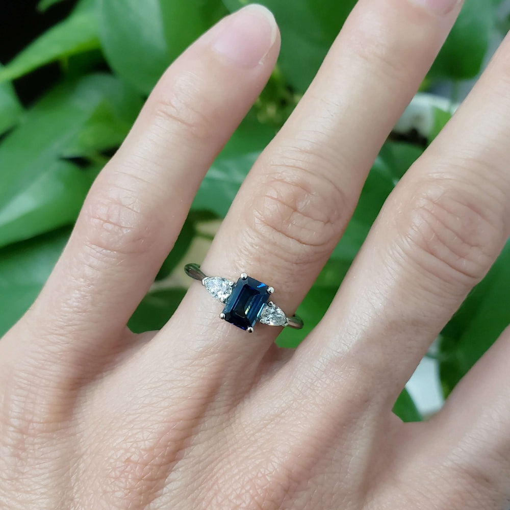 Australian sapphire and diamond three-stone ring in white gold, worn on hand