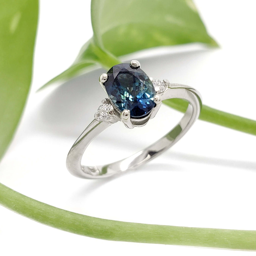 Australian sapphire and lab diamond engagement ring in white gold, shown with green leaf