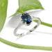 Australian sapphire and lab diamond engagement ring in white gold, shown with green leaf