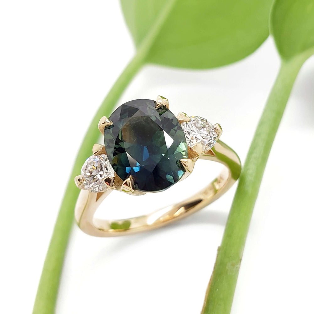 Australian sapphire and lab diamond engagement ring in yellow gold with leaf background