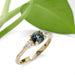 Australian sapphire and lab diamond ring in yellow gold, shown with green leaf background
