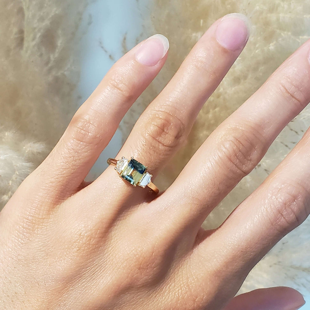 14kt yellow gold Australian sapphire and lab diamond ring worn on a hand