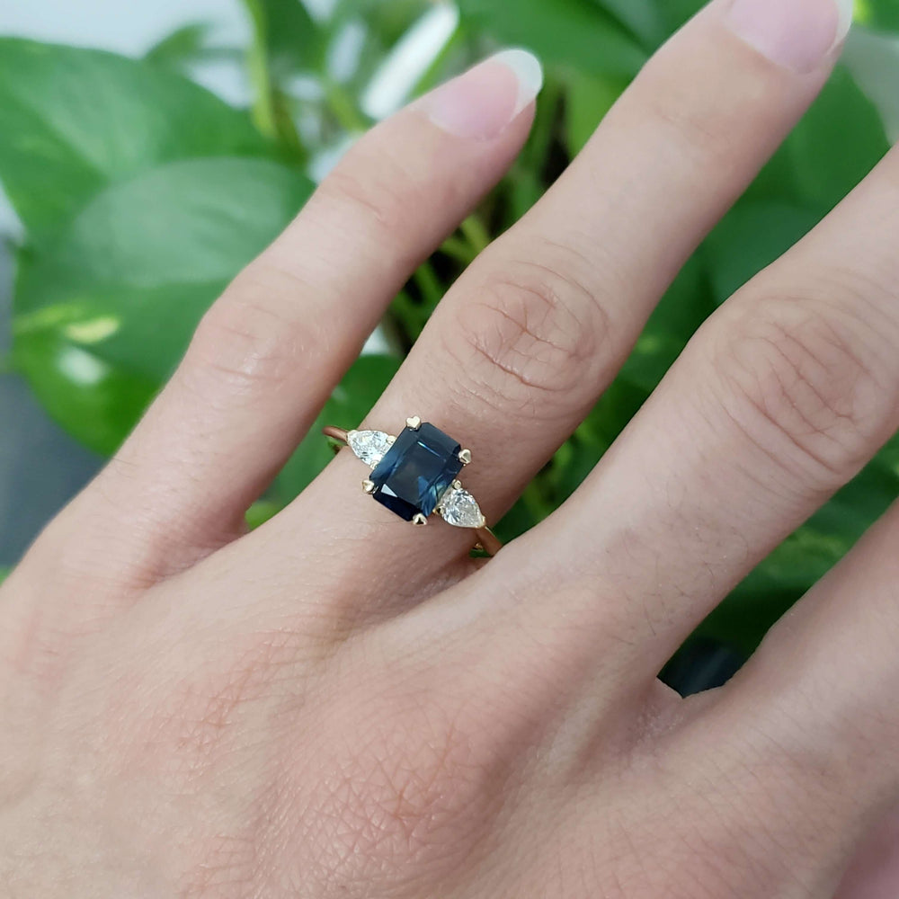 Australian sapphire and lab diamond yellow gold ring shown on a hand
