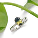 Australian sapphire engagement ring in white gold shown with green leaves