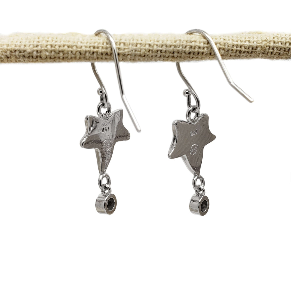 Back view of 14kt white gold leaf dangle earrings with hallmark and diamond settings