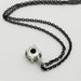 Back of 14kt white gold tsavorite garnet pendant with black chain