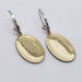 Back view of oval drop earrings showing polished yellow gold surface and white gold hooks