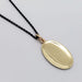 Back view of oval 14kt yellow gold pendant on a black chain