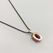 Back view of 14kt yellow gold pendant with oval pink sapphire and black chain