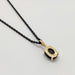 Back view of 14kt yellow gold star sapphire pendant on black chain