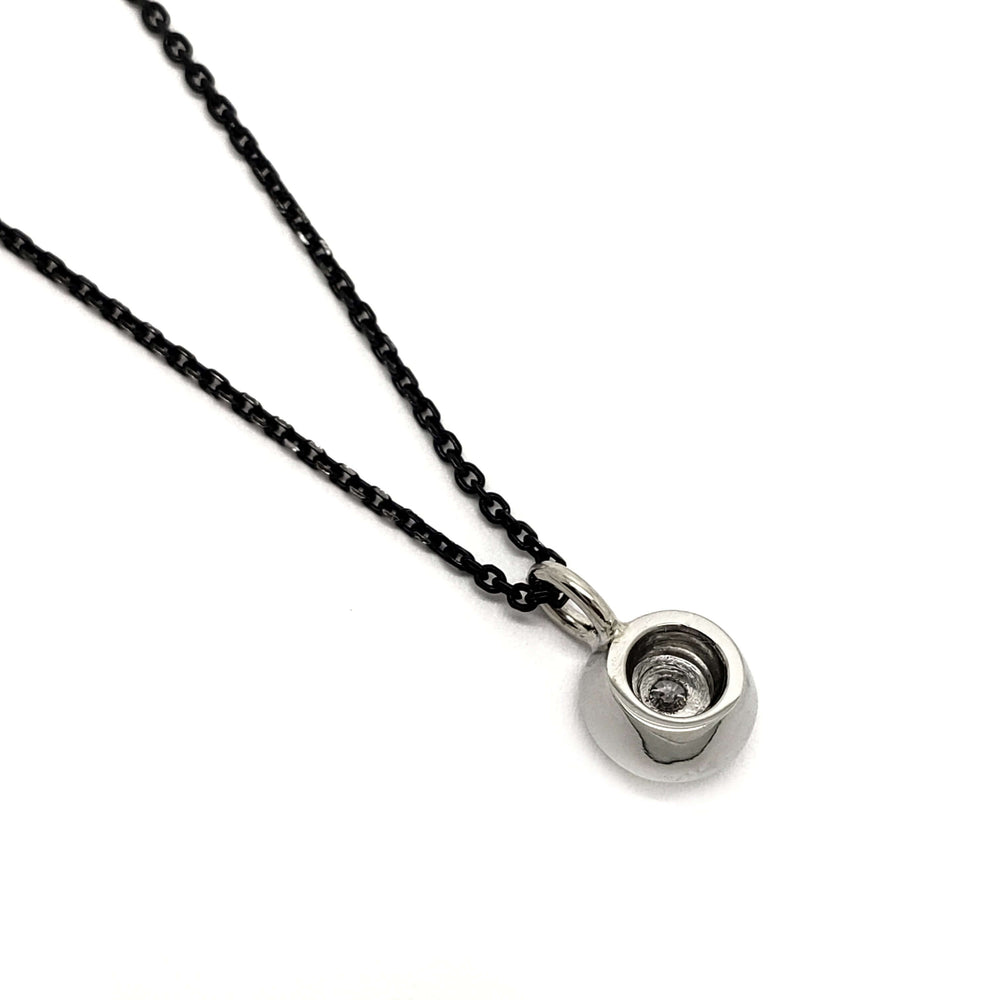 Back side of 14kt white gold Canadian diamond halo pendant, chain visible