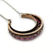 Reverse view of Victorian silver and rose gold crescent necklace with openwork gallery.
