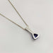 Back view of platinum trilliant tanzanite pendant on chain, white background