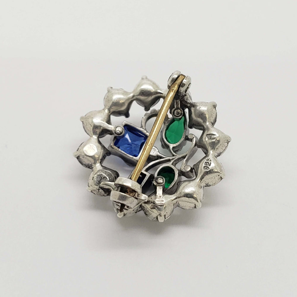 Back view of vintage sterling silver brooch showing pin and glass stone settings