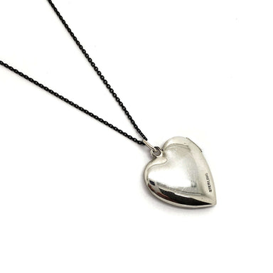 Back of vintage sterling silver heart locket showing 'STERLING' stamp