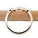 Back view of 14k rose gold wedding ring band on wood