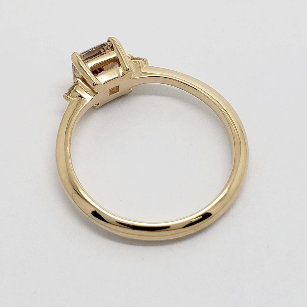 Back view of 14kt yellow gold engagement ring with raised cushion-cut champagne diamond