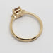 Back view of 14kt yellow gold engagement ring with raised cushion-cut champagne diamond