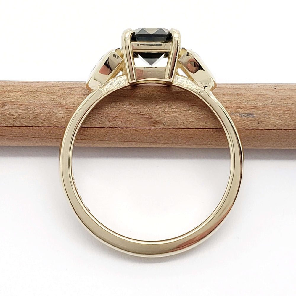 Back view of 14kt yellow gold ring with bi-coloured sapphire and trillion diamonds