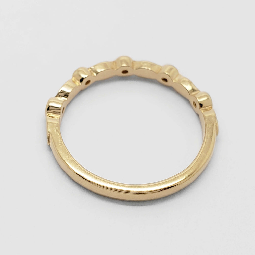 Back view of 14kt yellow gold wedding ring with leaf and diamond details
