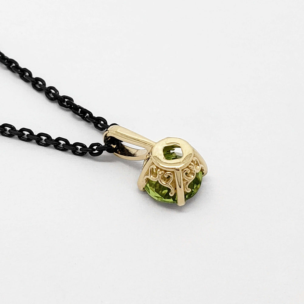 Back view of filigree 14kt yellow gold pendant with round green peridot