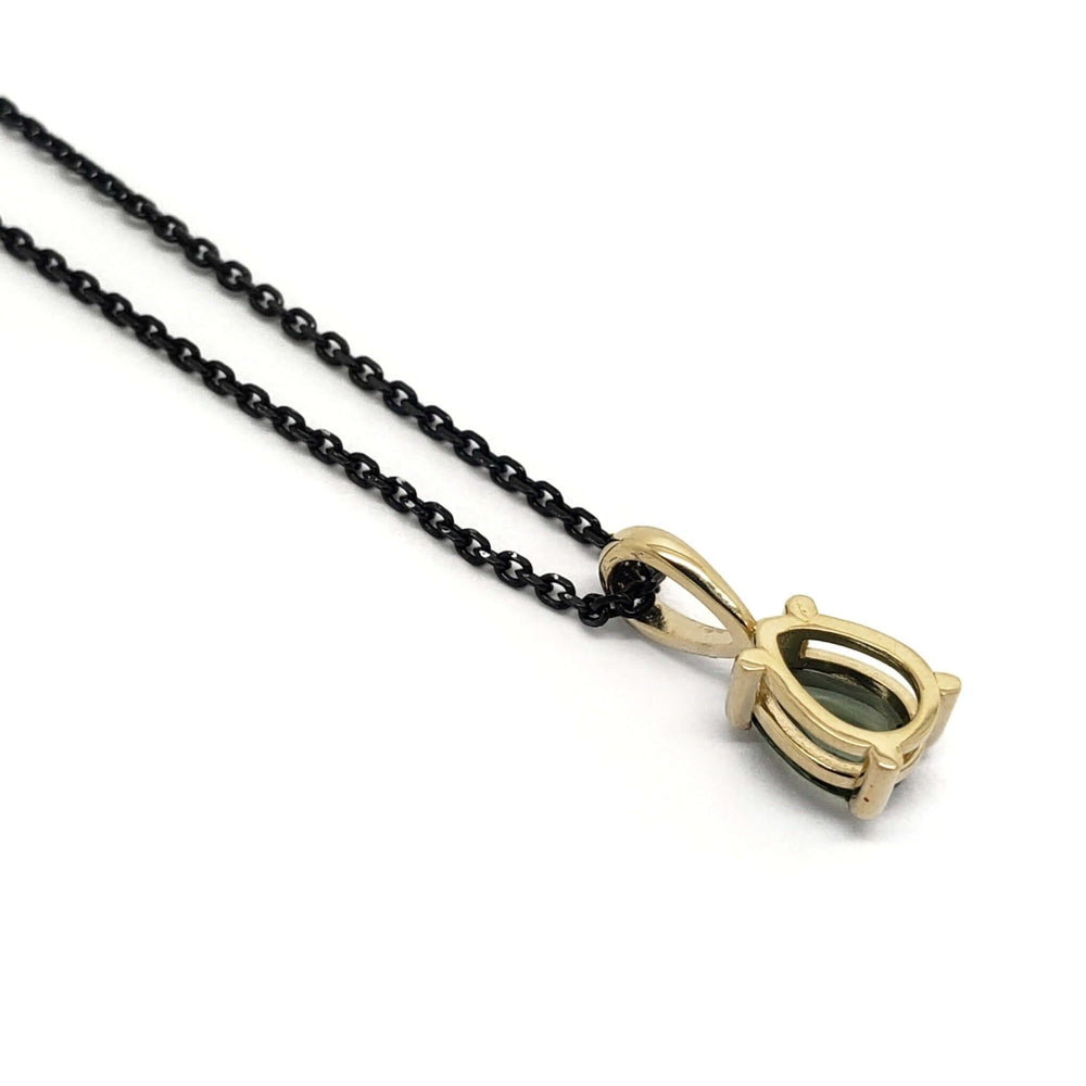 Back view of pear rose cut green sapphire pendant in 14k yellow gold on black chain