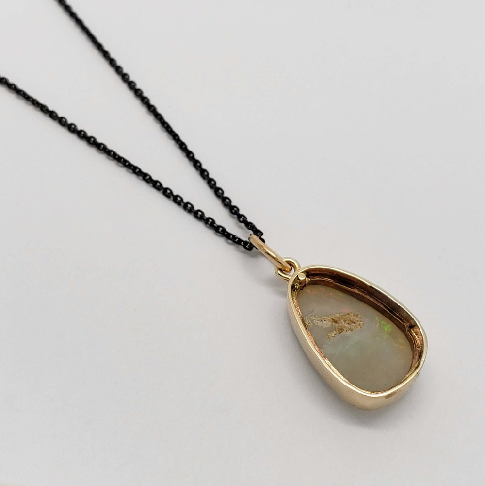 Back view of vintage opal pendant in 14kt yellow gold bezel setting