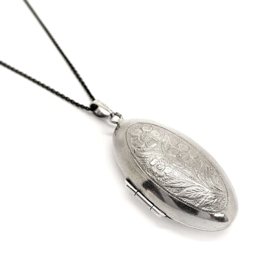 Back view of vintage sterling silver oval locket with detailed floral engraving