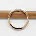 Back view of yellow gold chevron wedding ring on a wooden pencil