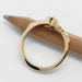 Back view of yellow gold ring with engraved leafy band and marquise blue sapphire