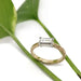 14kt yellow and white gold baguette diamond engagement ring displayed on green leaves