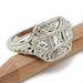 Bead-set diamond Art Deco engagement ring in 19kt white gold, shown on a wooden stick