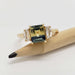 Bi-colour Australian sapphire and lab diamond yellow gold ring displayed on a pencil