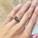 Bi-colour sapphire and lab diamond ring in yellow gold, worn on a hand