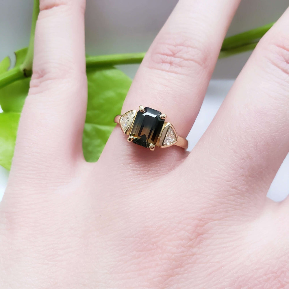 Bi-coloured sapphire and trillion diamond ring in 14kt yellow gold shown on hand