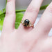 Bi-coloured sapphire and trillion diamond ring in 14kt yellow gold shown on hand