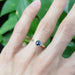 Blue sapphire and diamond ring in yellow gold shown on hand