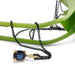Cushion cut blue sapphire pendant in yellow gold with black chain draped on a green stem