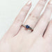 14kt white gold blue sapphire solitaire engagement ring shown on hand