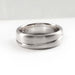 Brushed 14kt white gold wedding band with asymmetrical carved line, side view
