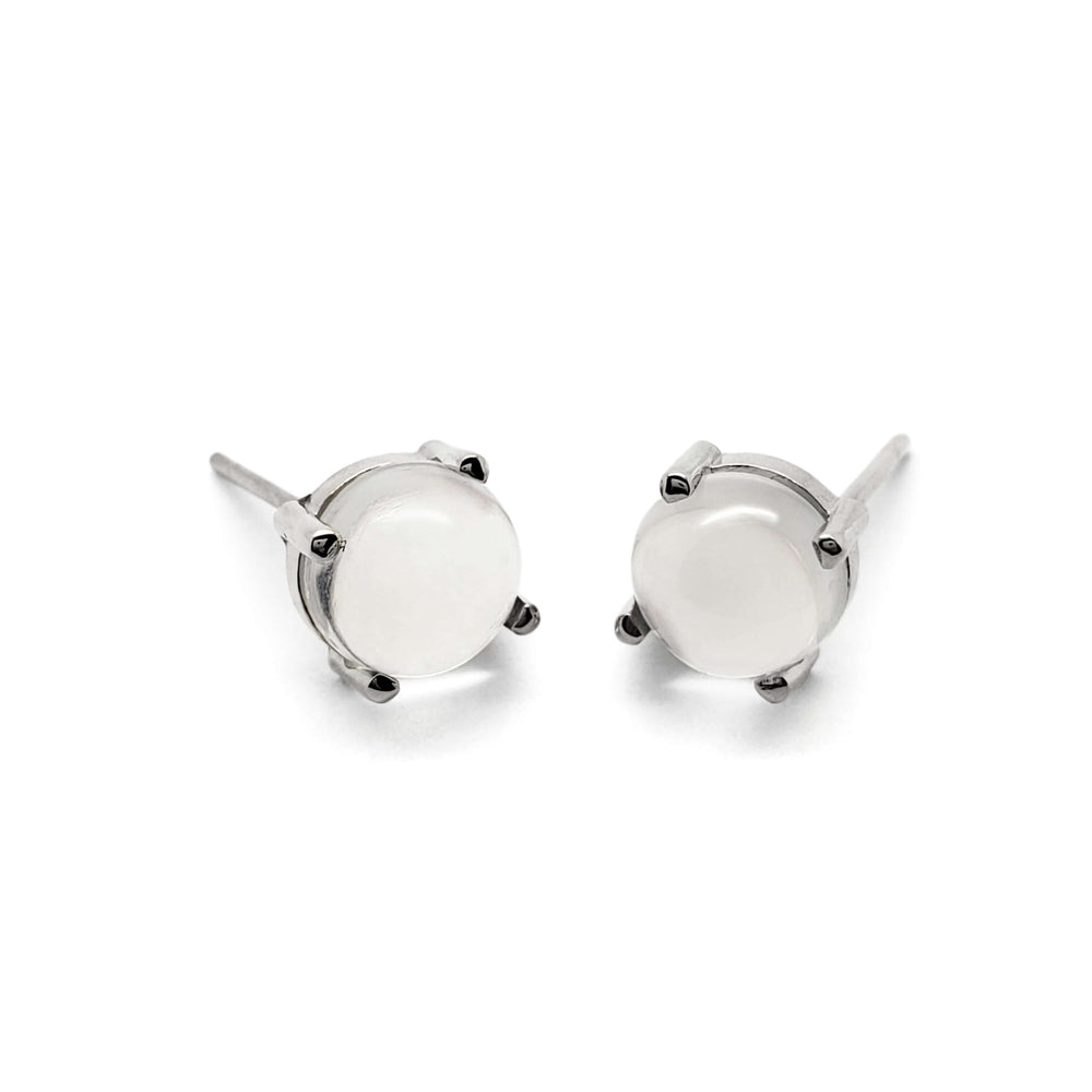 Pair of cabochon moonstone stud earrings in 14kt white gold on white background