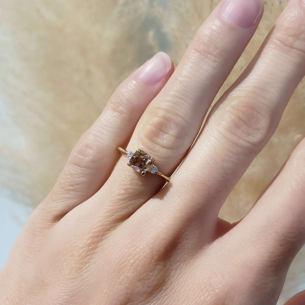 Champagne diamond and yellow gold engagement ring worn on hand
